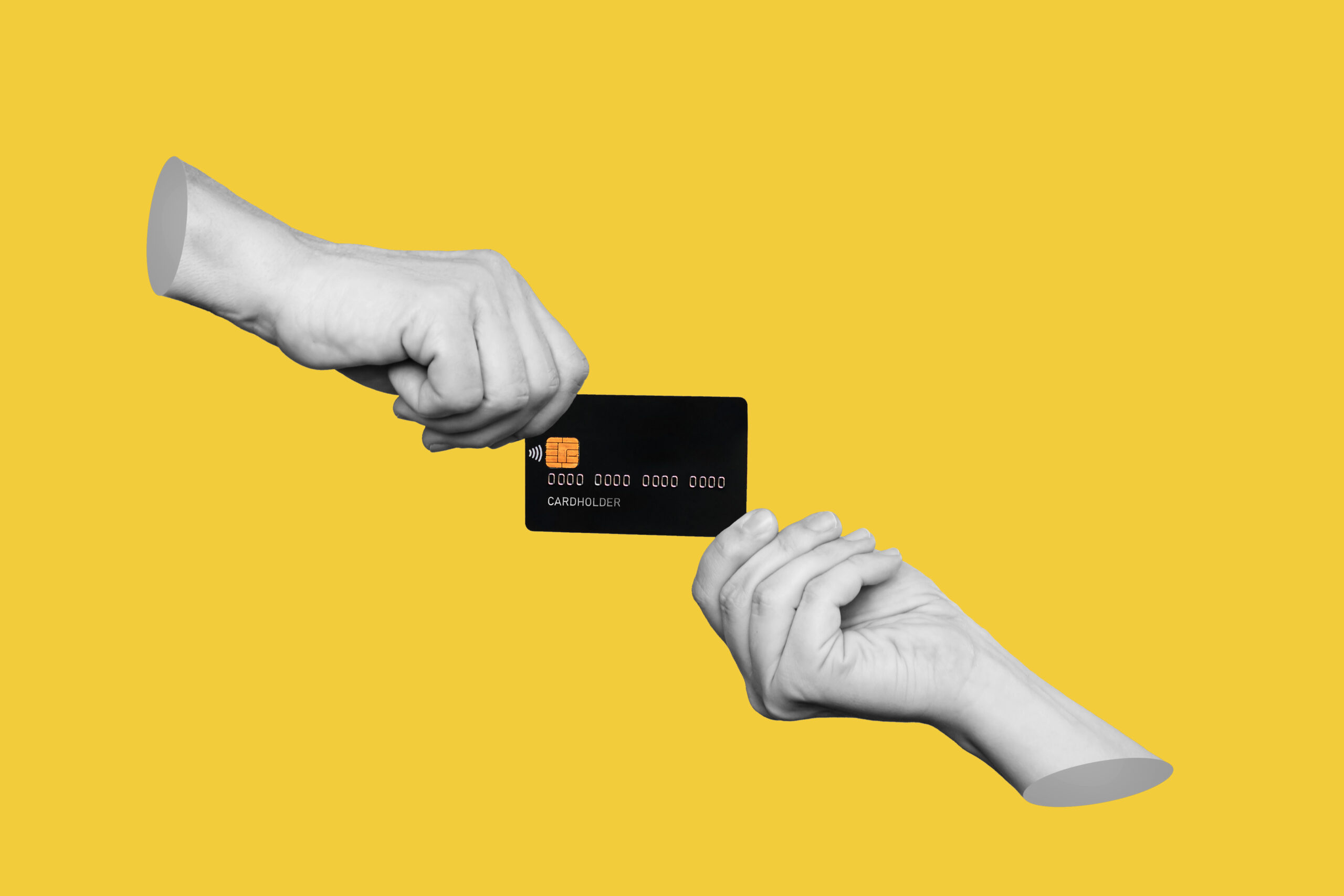 a right hand giving a credit card to a left hand with a yellow backdrop